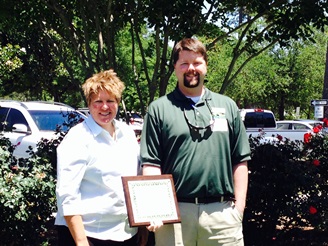 Image of CCPRC's Lynn Jenness and Chris Pounder with PRIDE award